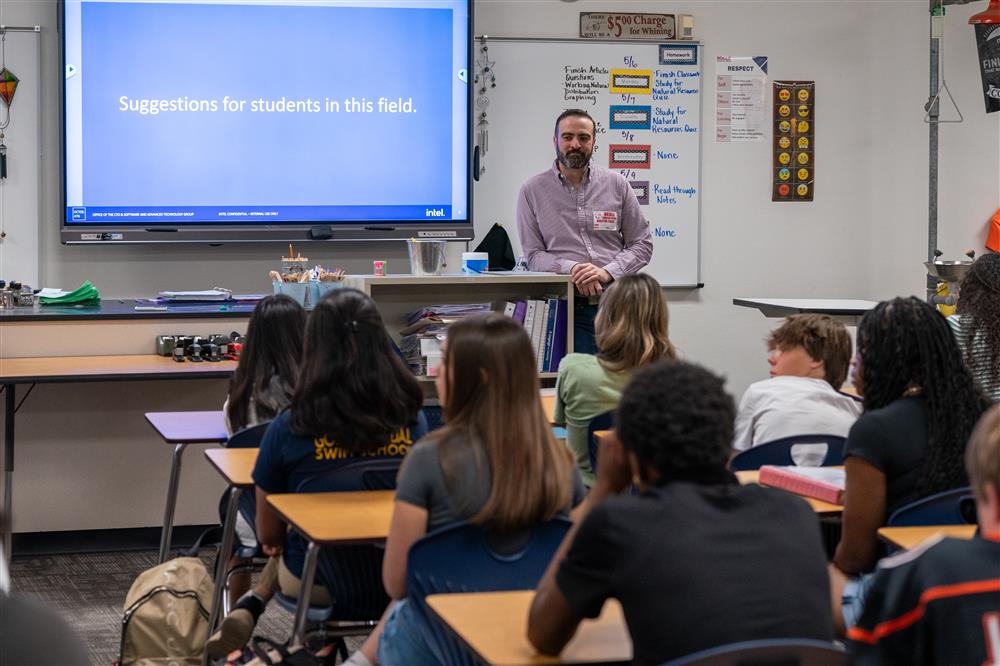 A guest speaker talks with a class.